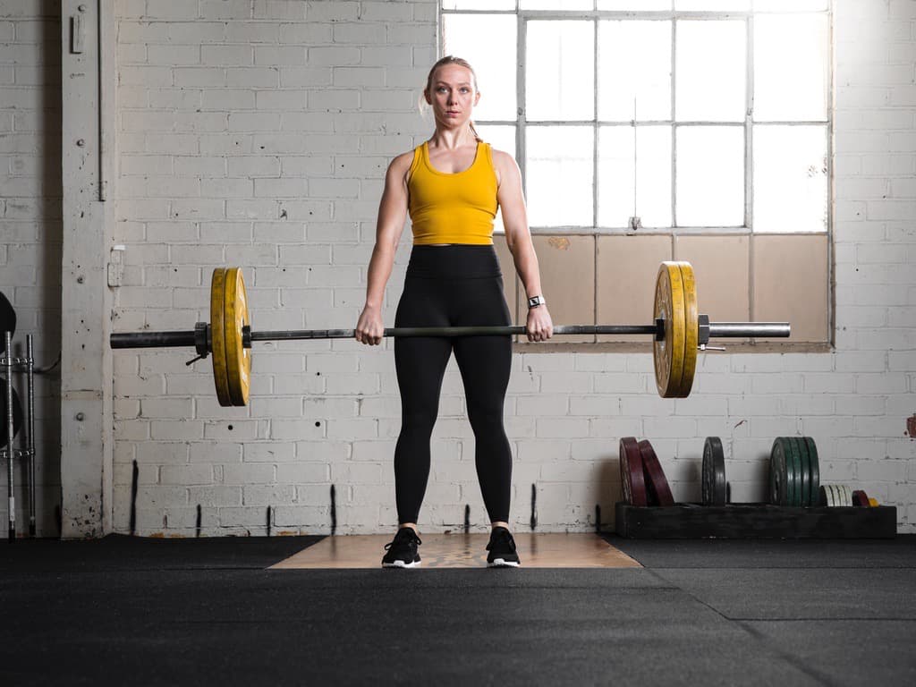 Dr. Hailey Andersen performing a barbell deadlift, demonstrating the functional strength training behind The Spine Studio's approach to care.