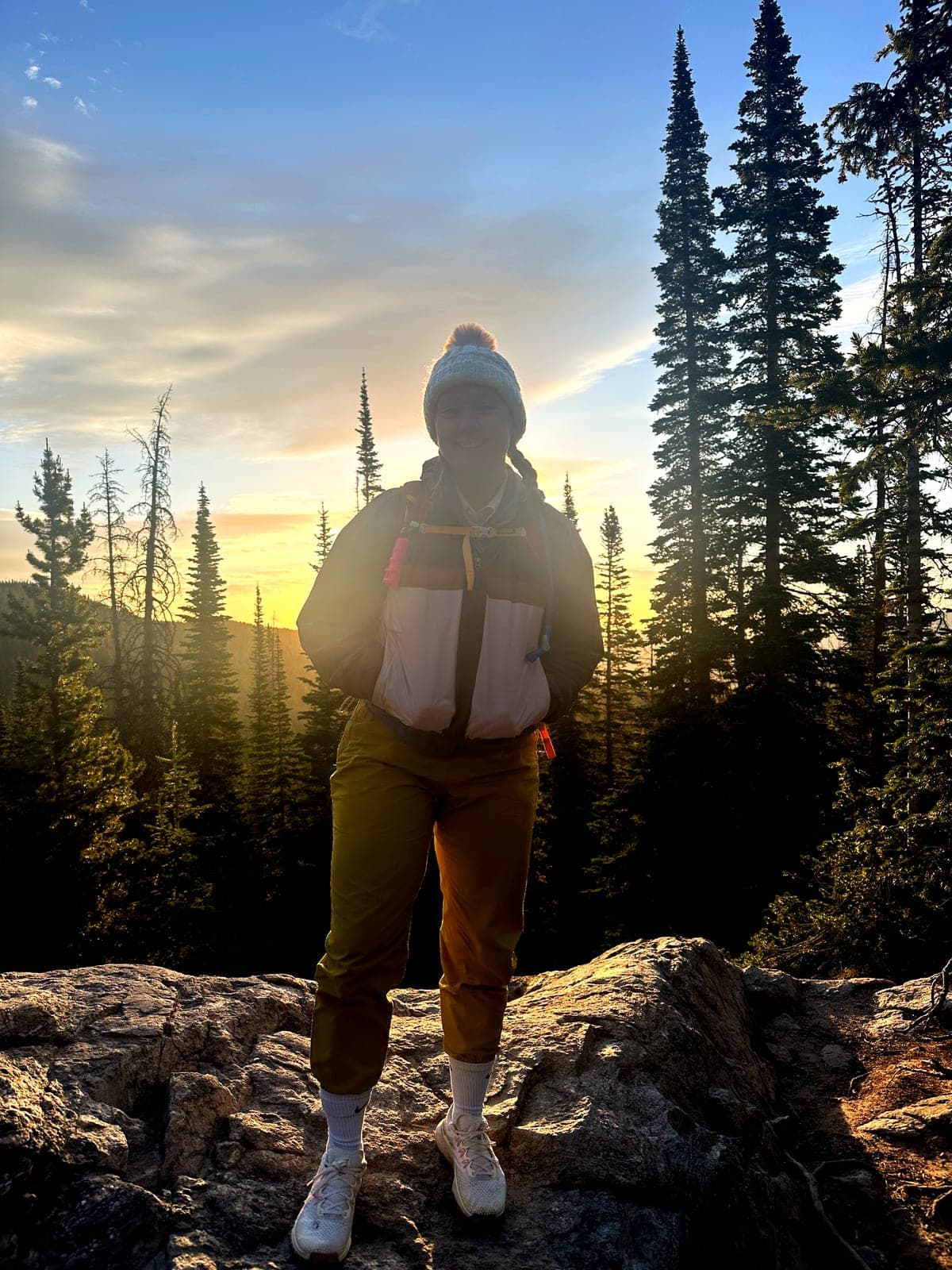 Dr. Hailey Andersen hiking a mountain trail at sunset